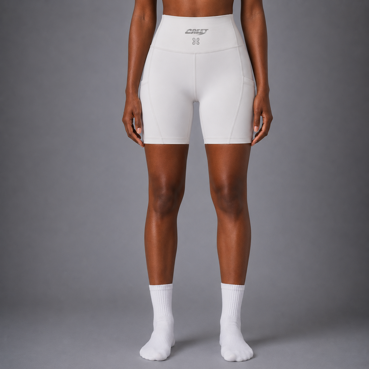 Woman wearing CREET white high-waisted biker shorts front view