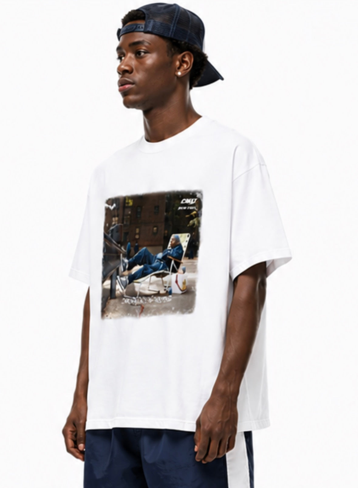 Model wearing CREET Can’t Knock The Hustle oversized white graphic T-shirt