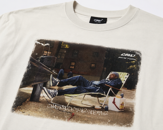 Close-up of CREET Can’t Knock The Hustle graphic print on white T-shirt